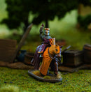 Miniature figure of a king on horseback with a blurred natural background