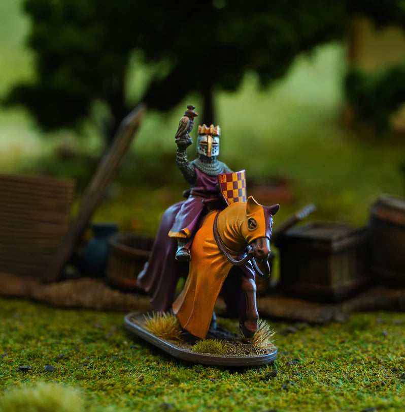 Miniature figure of a king on horseback with a blurred natural background