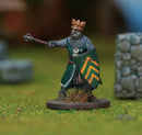 Miniature figure of a king with a crown, shield, and spear on a grassy field