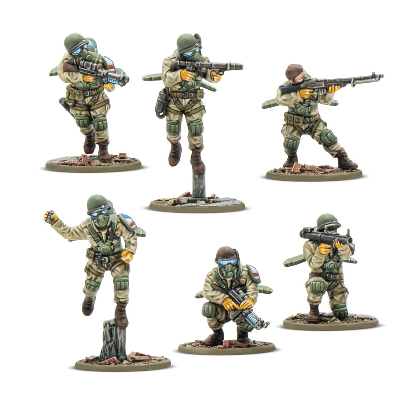 Six miniature figures of soldiers in tactical gear with weapons on a white background