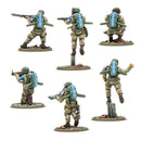 Six miniature figures of soldiers in military gear on a white background