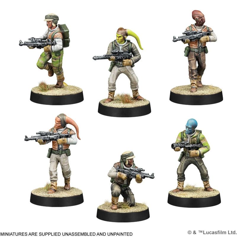 Six miniature figures of soldiers with weapons on round bases against a white background.