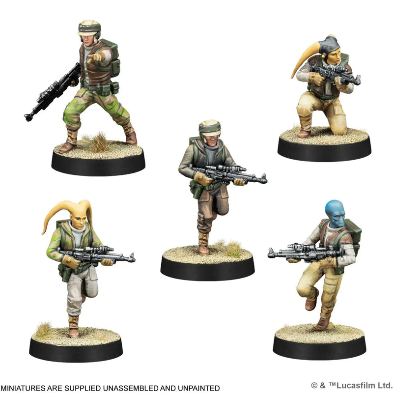 Five miniature figures of soldiers with weapons on round bases against a white background.