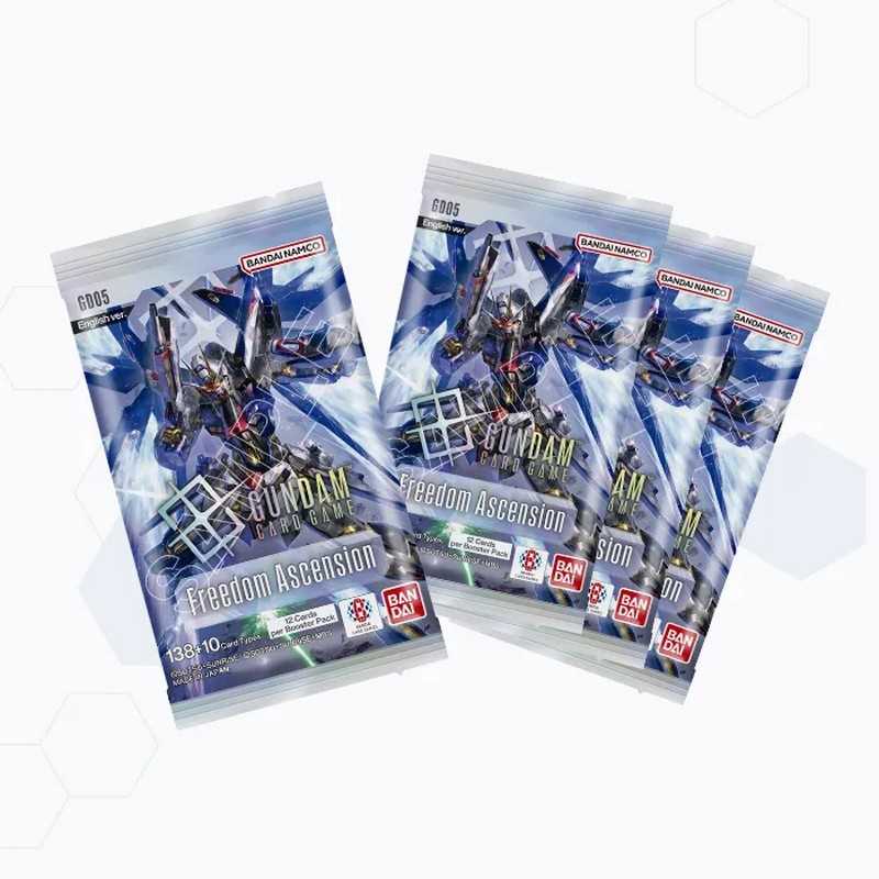 Three sealed Gundam card booster packs fanned out on a white background. The packs feature blue and white artwork with a Gundam robot figure and visible Bandai and Good Smile Company logos.