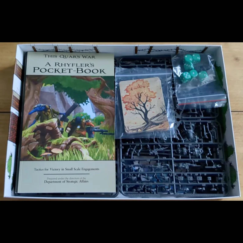 Board game components including a book, cards, and miniatures in an open box.
