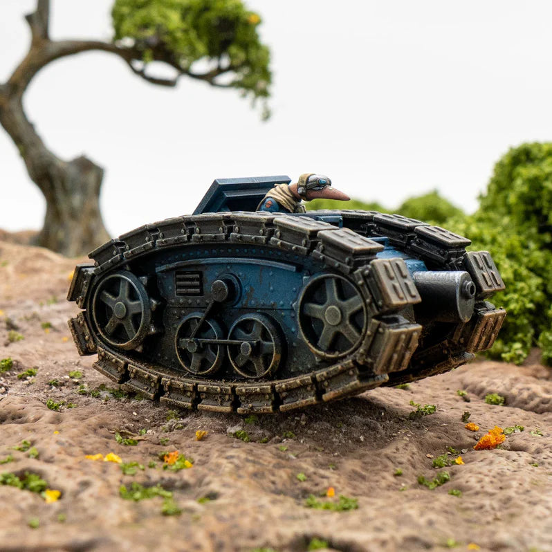 Toy tank on a rocky surface with greenery in the background