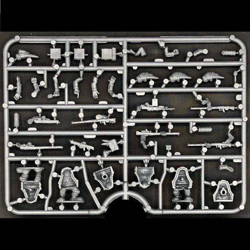 Set of miniature model parts on a black background