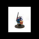 Figurine of a character with a drum and staff on a white background