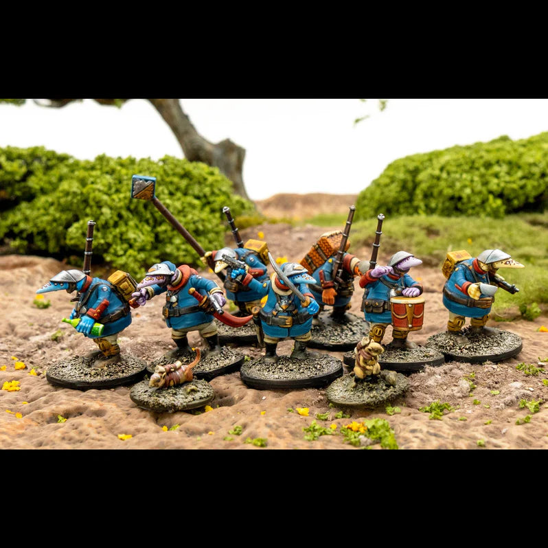 Miniature figures in blue armor with various weapons and accessories on a natural landscape background.