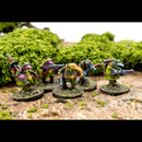 Miniature figures in green uniforms with weapons on a natural background