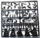 Set of black plastic figurine parts on a white background