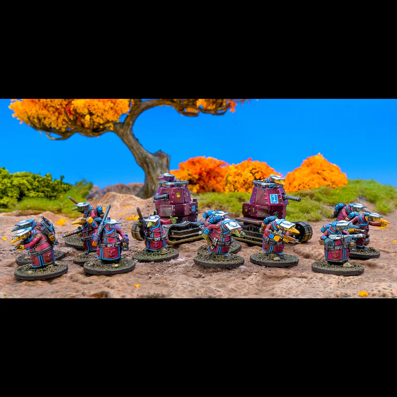 Miniature figures with vehicles on a scenic landscape with trees and blue sky.