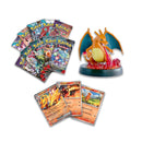 Collection of Pokémon trading cards and a Charizard figure on a white background