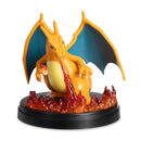 Dragon-like creature figurine with wings and fire, on a white background