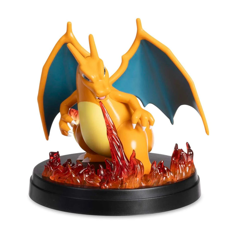 Dragon-like creature figurine with wings and fire, on a white background