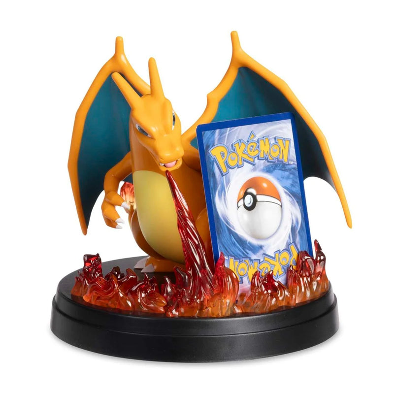 Dragon-like creature figurine with a Pokémon card on a white background