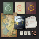 Collection of 'The One Ring' starter set items including books, map, cards, and dice on a dark background.