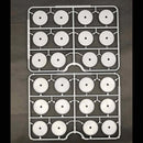 Two trays with white circular components on a dark background
