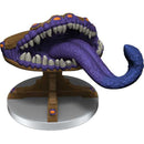 Monster figurine with open mouth and purple tongue on a white background
