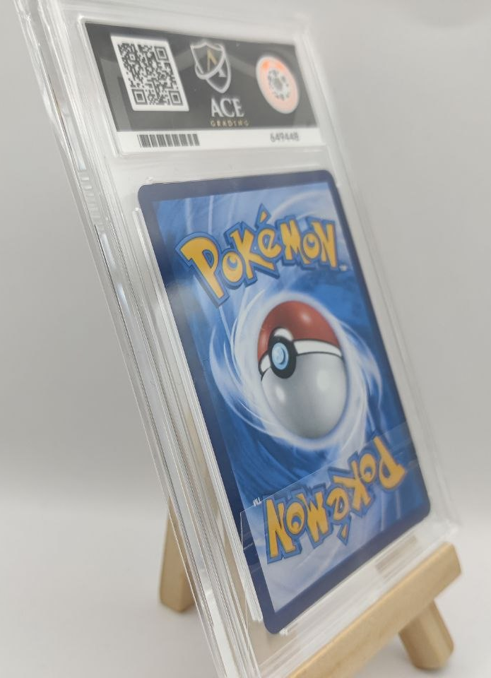 Pokémon trading card in a protective case on a stand with a white background