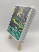 Card with a green creature illustration on a white background