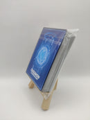 Digimon trading card deck on a small wooden stand with a white background