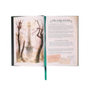 Open book with a scenic illustration on one page and text on the other, on a white background.