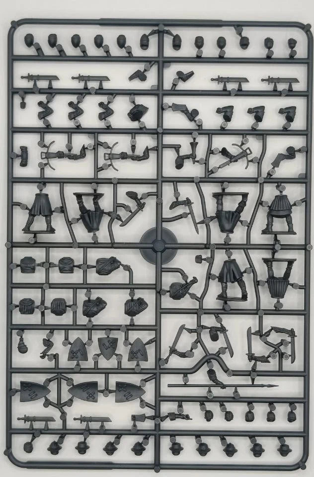 Plastic model kit tray with various small figures and parts on a white background