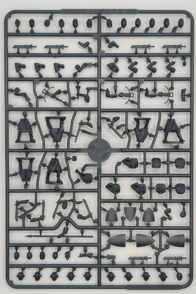 Plastic model kit with various small parts on a gray background