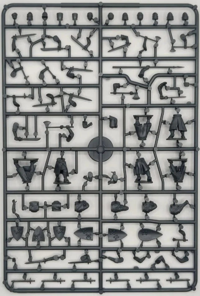 Plastic model kit with various pieces on a gray background