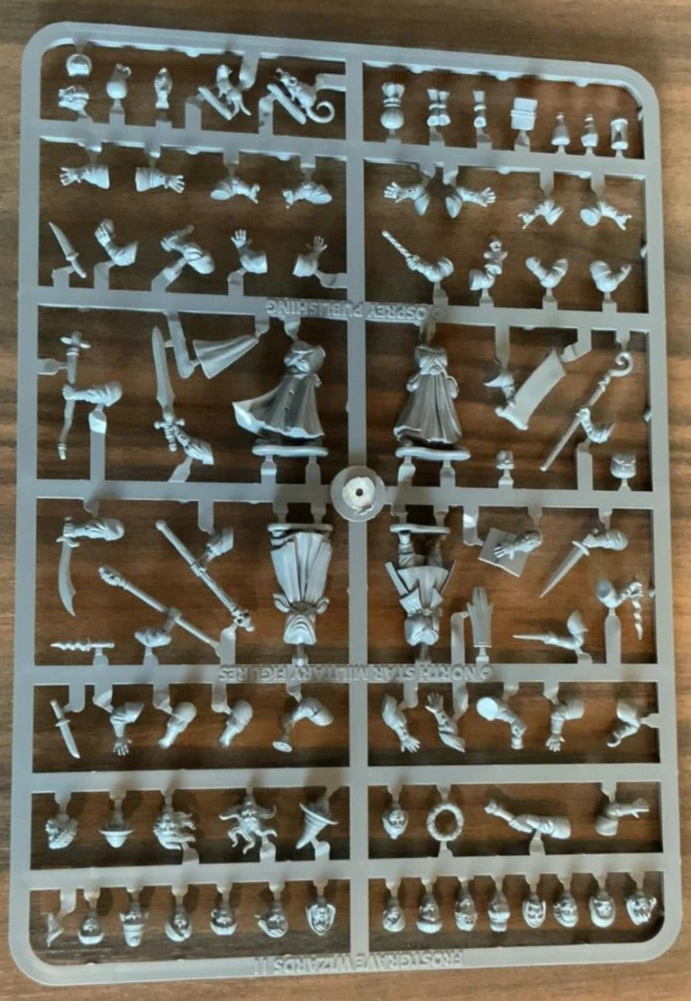 Plastic model kit with various small parts on a wooden surface