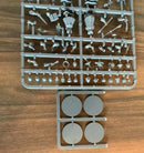 Set of miniature figures on a clear plastic tray on a wooden surface