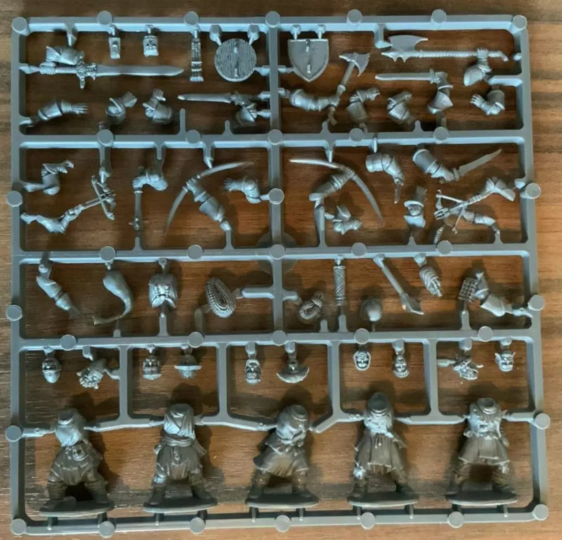 Plastic toy figures on a brown tray with a wooden surface background