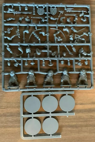 Plastic model kit with various miniature figures on a wooden surface