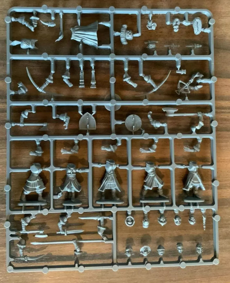 Plastic toy figures on a tray with various poses on a wooden surface