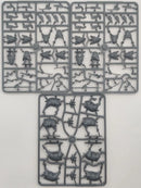 Three plastic model parts on a gray background
