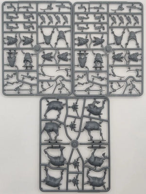 Three plastic model parts on a gray background