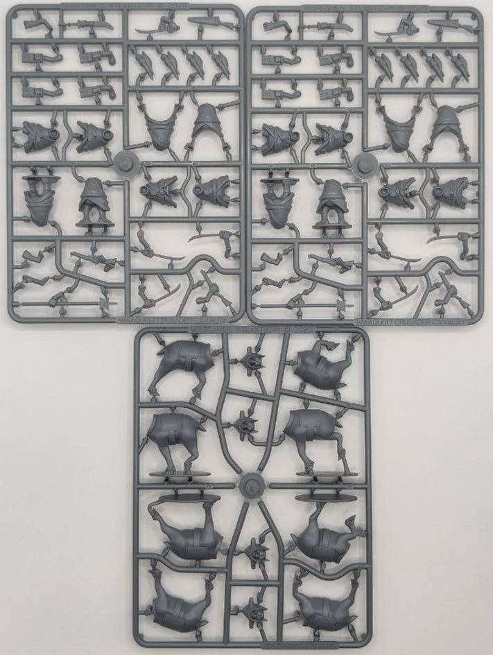 Three plastic model parts on a gray background