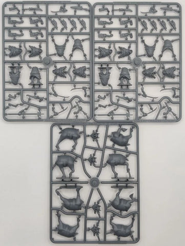 Three plastic model parts on a gray background