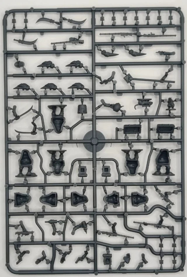 Plastic model kit tray with various small figures and objects on a white background