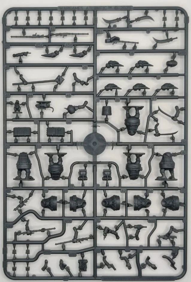Model kit tray with various small mechanical parts on a white background