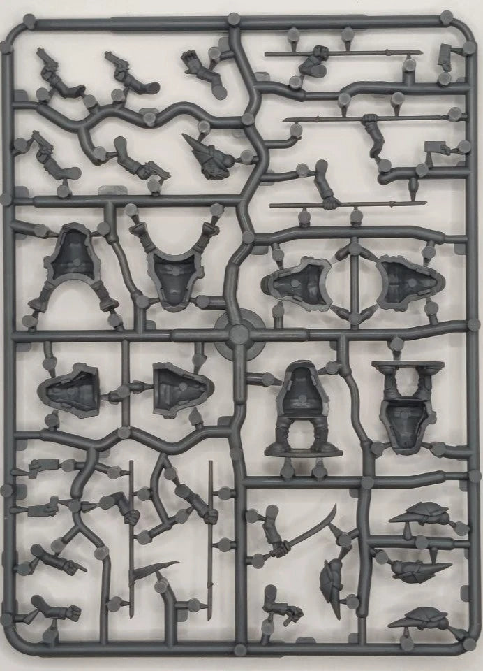 Plastic model kit component tray with various small figures and parts on a white background