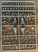 Plastic figurine parts on a tray with a wooden background