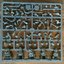 Plastic mold with miniature figures and accessories on a wooden surface