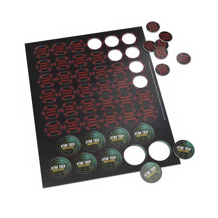 Star Trek cardboard token set with a black backing sheet and several round tokens printed with Star Trek and Alaskan Native designs, shown on a white background.